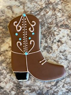 a cookie shaped like a cowboy boot sitting on top of a counter