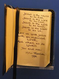 an open book with writing on it and a note attached to the front cover that says jesus is the truth