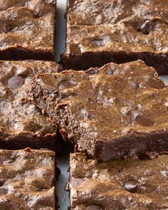 chocolate brownies cut into squares and stacked on top of each other, ready to be eaten