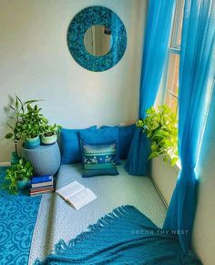 an instagram page with a blue couch and pillows in the corner, surrounded by potted plants