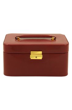 a red box with gold handles and handle on it's side, sitting against a white background