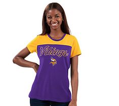 Gear up for game time while looking a little glam. This cute color-block tee features your fave team's name in a shimmery glitter print. Collegiate Purple Top For Sports Events, Purple Collegiate Tops For Sports Events, Purple Fan Gear Tops With Team Name, Purple Tops With Team Name For Fan Gear, Collegiate Purple Top For Game Day, Purple Letter Print Top For Sports Fans, Purple Tops With Letter Print For Fan Gear, Purple Letter Print Tops For Fan Gear, Varsity Style Team-colored Tops For Fans