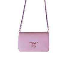 This minibag by Prada is a must-have piece to carry your essentials in style. It features a tonal Prada logo on the front and a tonal chain strap matching the color of the bag. This mini bag opens to a black nappa interior with one patch pocket and three card slots. Made in Italy by Prada. Prada Saffiano Minibag with chain strap padded with matching Saffiano leather Dimensions: 7 x 4.5 x 1.75 in (WHD) Lined with black Nappa Leather Tonal Logo on the flap and tonal chain matching bag color One patch pocket and three card slots inside Printed Logo inside in silver tone Made in Italy All of our products are brand new and authentic. We provide proof of authenticity documentation upon request. We accept free returns up to 30 days after your purchase. Shop with confidence, we are available via c Everyday Saffiano Leather Bag With Chain Strap, Saffiano Leather Bags With Chain Strap For Everyday Use, Leather Mini Bag, Prada Logo, Prada Saffiano, Nappa Leather, Leather Mini, Mens Shirt Dress, Cloth Bags