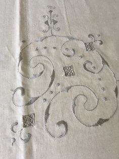 an embroidered piece of cloth with designs on it