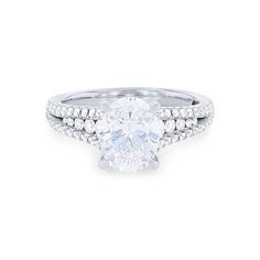 a white gold engagement ring with an oval cut diamond surrounded by pave set diamonds