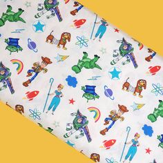 an image of children's fabric with cartoon characters and stars on white cotton material