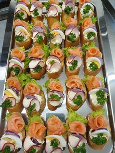 a platter filled with lots of different types of appetizers on top of each other