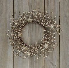 a wreath with white flowers on a wooden fence