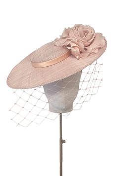 Classically elegant disc hat with flower and veil.‘Aurelia’ is a perfectly proportioned and flattering silhouette to see you through the summer season.From Weddings to the Royal Enclosure at Royal Ascot, a timeless style that is light and comfortable to wear.The soft wire headband discretely keeps the hat in place and is effortless to put on, with no risk of ‘hat hair’. --- Pinokpok base with silk flower and trim. Dye-to-Match Colour service offered for the style. Luxury Traditional Wedding Hats, Luxury White Costume Hats And Headpieces For Royal Ascot, Luxury Elegant Hat For Celebration, Luxury Elegant Hats For Women, Luxury Elegant Six-panel Hat, Luxury Formal Hats For Royal Ascot, Luxury Elegant Hats And Headpieces For Royal Ascot, Luxury Elegant Hats For Fall, Luxury White Hat For Ceremony