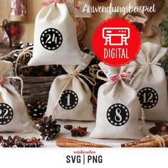 three bags with numbers on them are sitting next to pine cones and cinnamon stickers