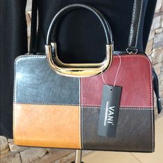 Vani Patchwork Handbag. Silver Handles. Leather-Look With Zipper Top. Includes Zippered Insert With Pocket. Fully Lined With Zippered Pocket Inside Main Compartment. Removable Black Crossbody Strap. Colors Are Black, Maroon, Tan, Dark Brown. Brand New, With Tag. Never Used. Dimensions: 11-1/4” Wide X 7-3/4” High (Plus 4” To Top Of Handle) X 3” Deep. Brown Square Box Bag With Handles, Brown Square Satchel With Handles, Brown Large Capacity Satchel For Evening, Brown Square Evening Bags, Elegant Multicolor Shoulder Bag For Office, Brown Evening Bags For Fall, Brown Evening Bag For Fall, Brown Evening Satchel For Fall, Chic Multicolor Fall Bags