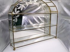 a mirror that is sitting on top of a shelf in the shape of a birdcage