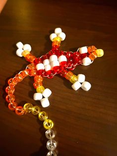 a cross made out of beads on a table