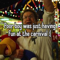 a man holding a stuffed animal in his arms with the caption poor boy was just having fun at the carnival