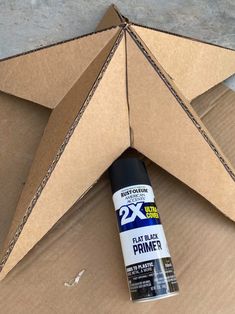 an open cardboard box with a black glue on it and a star shaped object in the middle