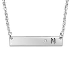 Create a meaningful gift or a cherished keepsake and inscribe your favorite initial onto this sleek women's bar pendant necklace, punctuated with a brilliant diamond accent. Fashioned in 10K white gold, the 18-inch rope chain secures in place with a spring ring clasp. Free personalization! Please provide one initial for this item if you wish to personalize it. Classic Diamond Accented Bar Necklace For Anniversary, Classic Bar Necklace With Diamond Accents For Anniversary, Classic Diamond Accents Bar Necklace For Anniversary, Silver Initial Necklace With Rectangular Pendant For Anniversary, Silver Rectangular Pendant Initial Necklace For Anniversary, Classic Silver Bar Necklace For Anniversary, Classic Initial Necklace With Single Diamond For Anniversary, Sterling Silver Bar Necklace For Anniversary, Classic Bar Necklace With Diamond Accents For Gifts