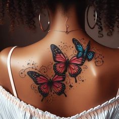 the back of a woman's neck with two butterflies on her upper and lower part