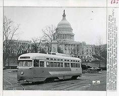 an old photo of a trolley in front of the capitol building