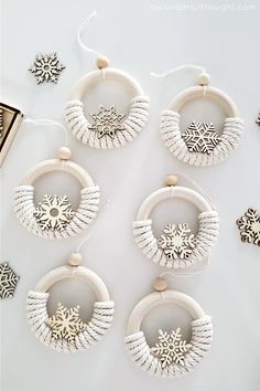 white wooden hoop earrings with snowflakes hanging from them