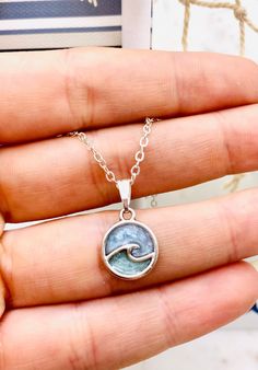 "This beautiful ocean wave necklace is perfect for any occasion!  Love that feeling of peace that the Ocean always seems to bring? Imagine taking the beach with you everywhere you go! This beautiful handmade resin necklace makes the perfect jewelry choice for a beach vacation, a gift for a best friend, or just a reminder of the sea.  Necklace is handmade with resin, and your choice of either silver plated or sterling silver necklace chain.  Chain Length: 18 or 20 inches long  CHOICES OF CHAIN MA Ocean Jewelry Necklaces, Ocean Gift Ideas, Adjustable Ocean-inspired Necklace, Ocean-inspired Strand Charm Necklaces As Gift, Coastal Style Adjustable Necklaces As A Gift, Ocean-inspired Adjustable Charm Necklace Gift, Ocean-inspired Nickel Free Necklace For Beach, Ocean-inspired Nickel-free Necklace For Beach, Ocean-inspired Round Necklace For Beach