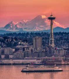 the space needle in seattle, with mount rainier in the background