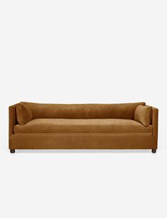 a brown couch sitting on top of a white floor