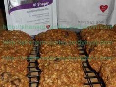 oatmeal cookies cooling on a rack next to a bag of v - shape