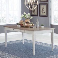 a dining room table with some food on it and pictures above the table in front of them