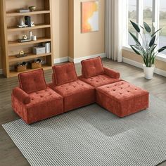 a living room with an orange sectional couch and large rug on the floor in front of it