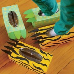 a person standing on top of two boxes with scissors in them and some zebra print