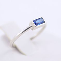 SOLID STERLING SILVER dainty ring with a sapphire (blue) color rectangular-shaped gemstone. The ring is rhodium plated. It is white gold color. The unique jewelry you can find, a perfect gift for you and your loved one. It's dainty but sturdy and can be worn every day. A special piece you'll truly treasure! High-quality materials and attention to detail. High polished finish. The price is for ONE ring. This dainty, elegant, but sturdy ring comes in a gift box. SIZING INFO: Please be sure you hav Modern Rectangular Blue Sapphire Ring, Modern Blue Rectangular Sapphire Ring, Rectangular Sapphire Ring For Gift, Modern Rectangular Sapphire Ring For Gift, Modern Rectangular Sapphire Ring, Modern Rectangular Sapphire Ring Gift, Rectangular Sapphire Birthstone Ring As Gift, Minimalist Gold Sapphire Ring In Sterling Silver, Minimalist Sapphire Ring With Sterling Silver