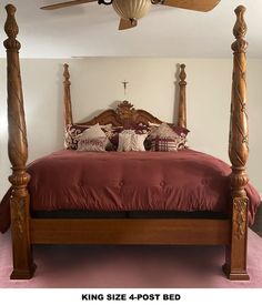 a bed with four posts and pillows on it