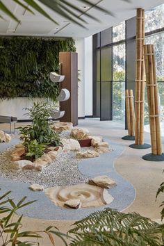 an indoor area with plants and rocks in it