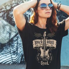 A great Guitar Rock n Roll T shirt to wear when you are going to concert or as a great gift for those who love Guitars and Rock n Roll. Pair it with your favorite jeans or jean skirt, jean jacket and sneakers. This classic unisex jersey short sleeve tee fits like a well-loved favorite. Soft cotton and quality print make users fall in love with it over and over again. These t-shirts have-ribbed knit collars to bolster shaping. The shoulders have taping for better fit over time. Dual side seams ho Rock Style T-shirt With Band Logo For Music Festivals, Rock And Roll Short Sleeve T-shirt For Concert, Rock Style Crew Neck T-shirt For Music Festival, Rock And Roll Graphic T-shirt For Music Festival, Rock Style Screen Print T-shirt For Music Festival, Rock And Roll Graphic Design Short Sleeve Tops, Rock Style T-shirt For Summer Concerts, Music-themed Concert Tops With Graphic Design, Music-themed Graphic Tops For Concerts