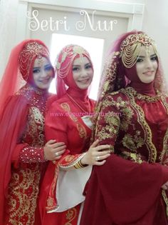 three women dressed in red and gold are posing for the camera with their headscarves