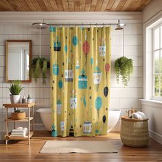 a bathroom with a yellow shower curtain and wooden floors