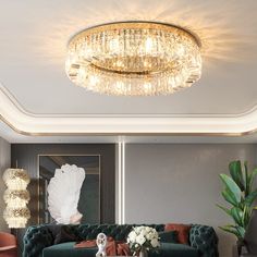 a living room filled with furniture and a large chandelier above the couches