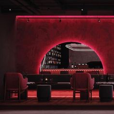 a dimly lit restaurant with red lighting and chairs