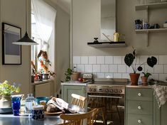 the kitchen is clean and ready to be used for cooking or baking, with dishes on the table