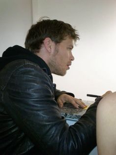 a man sitting in front of a laptop computer