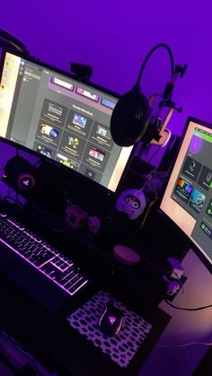 two computer monitors sitting on top of a desk in front of a keyboard and mouse