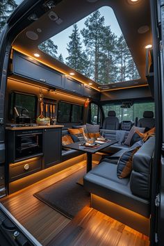 an interior view of a camper van with the kitchen and living room in it