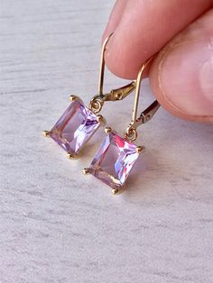 Pink Amethyst Earrings, February Birthstone, Lavender Rectangle Earrings in Gold or Silver, Emerald Cut Earrings, Amethyst Jewelry Mom Gift These elegant baguette earrings feature light pink amethyst rectangle gemstones prong set in your choice of gold filled or sterling silver. The lavender drops are suspended from lever back ear wires in the finish of your choice. These are great choice for simple yet elegant earrings to wear virtually anywhere. Ideal gift for a women born in February, as this Purple Rectangular Jewelry For Party, Emerald Cut Earrings, Baguette Earrings, Baguette Earring, Cut Earrings, Rectangle Earrings, Amethyst Jewelry, Earrings In Gold, February Birthstone