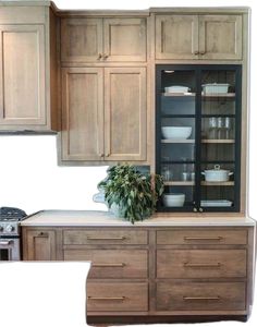 an image of a kitchen setting with wooden cabinets and dishes on the counter top in front of it