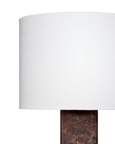 a table lamp with a white shade on it's base and a wooden structure