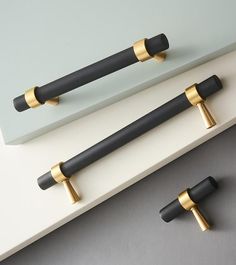 two black and gold handles on a white counter