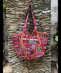 About bag  Indo-gypsy fusion, everyday use hand bag made from Banjara fabrics sourced from Vintage tribal costumes of regions of Rajastan and Gujarat. These are embellished with light catching coins, and intricate bead work tassels. Size - length 15 inches/ width 21 inches Company details:  Company name: Houseoftextile  Contact number: +919784447473  Email id: houseoftextile77@gmail.com  Shipping & custom : Delivery through one of the finest service providers : Skyway, Fedex, UPS  And DHL. Any l Festive Embroidered Tote Bag, Red Bags With Mirror Work For Festivals, Red Rectangular Bags With Motifs, Embroidered Hobo Tote Bag For Festival, Multicolor Embroidered Tote Bag With Mirror Work, Traditional Summer Shoulder Bag, Red Bohemian Shoulder Bag For Festival, Multicolor Embroidery Mirror Work Tote Bag, Handmade Festive Shoulder Bag