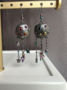 Add a cosmic touch to your style and rock a look that's out of this world with jewelry from Cosmic Created Magic! These space earrings are so cool, the metal full moon has a matte finish. The earrings, rhinestones, astronauts, and stars are all rainbow holographic giving these earrings a trippy color changing look! These earrings are great for lovers of space! Space Earrings, Rainbow Holographic, Rock A, Moon Earrings, Out Of This World, Full Moon, Jewelry Earrings Dangle, Dangle Drop Earrings, Etsy Accessories