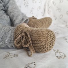 "Beautifully soft, these alpaca baby booties with an adjustable ankle tie will keep your little one's feet warm and snug. These are hand knitted in 100% baby alpaca that has a soft texture, the silky look and feels luxurious to the touch.  Light brown is a gorgeous shade and the perfect choice for gender neutral new baby gift. Booties can be paired with our knitted beanie of different designs and colours.  - Hand knitted in 100% baby alpaca  - Natural insulator, keeps warm in winter and will als Neutral Clothes, Knitted Shoes, Alpaca Baby, Newborn Socks, Keepsake Baby Gifts, Gender Neutral Clothes, Brown Hand, Knit Shoes, Knit Alpaca