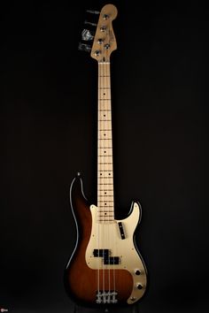 an electric bass guitar is shown against a black background